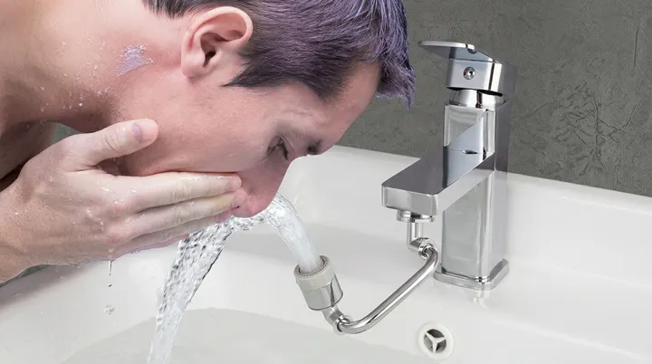 Hibbent 1080° rotatable faucet extender spraying water into a kitchen sink